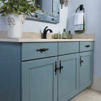 A bathroom vanity with a vessel sink, a decorative mirror, and a towel rack.