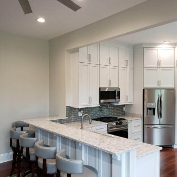 Floor to ceiling kitchen with peninsula bar