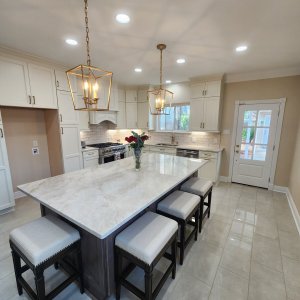 Breathtaking Metairie quartzite countertops in the sought-after North Bridgedale neighborhood of Jefferson Parish. This long, elegant island is fabricated from Premium Taj Mahal Quartzite, providing a highly durable, scratch-resistant workspace with ample breakfast bar seating for friends and family. Premium Taj Mahal Quartzite kitchen countertops featuring a long island with seating in the North Bridgedale neighborhood of Metairie, Louisiana.