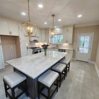 Breathtaking Metairie quartzite countertops in the sought-after North Bridgedale neighborhood of Jefferson Parish. This long, elegant island is fabricated from Premium Taj Mahal Quartzite, providing a highly durable, scratch-resistant workspace with ample breakfast bar seating for friends and family. Premium Taj Mahal Quartzite kitchen countertops featuring a long island with seating in the North Bridgedale neighborhood of Metairie, Louisiana.
